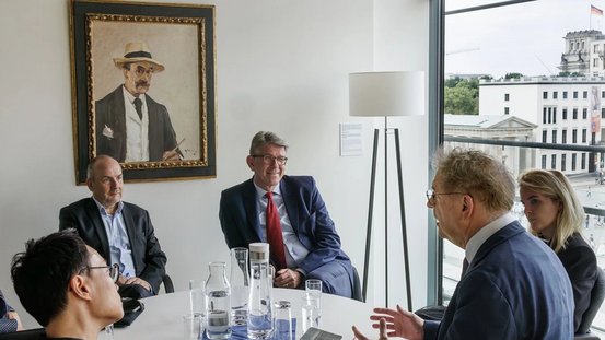 Kulturstaatsminister Wolfram Weimer unterh&auml;lt sich in einem Raum der Akademie der K&uuml;nste mit Blick auf den Pariser Platz mit dem Pr&auml;sidentenduo Manos Tsangaris und Anh-Linh Ngo.